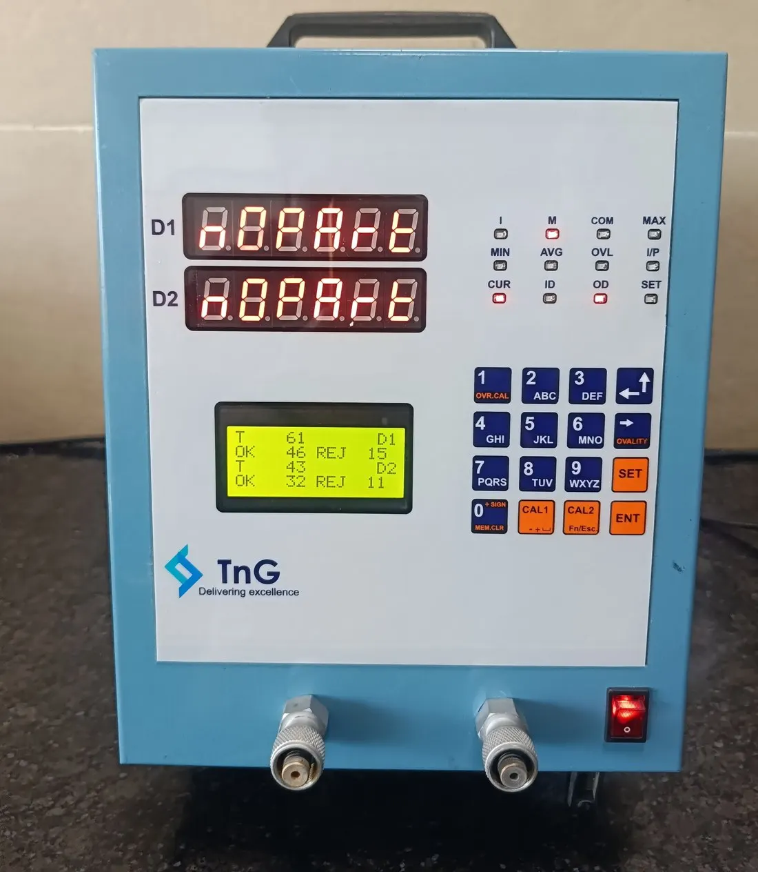 TnG 2-channel piezo gauge with two red readouts labelled D1 and D2, a green LCD and a numeric keypad.